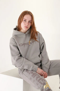 Collection of woman standing with a christian athletes hoodie white background cross logo in a gallery layout
